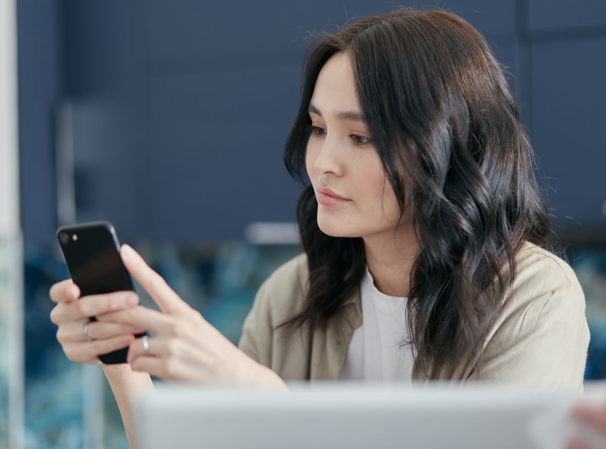 A young woman focused on her smartphone